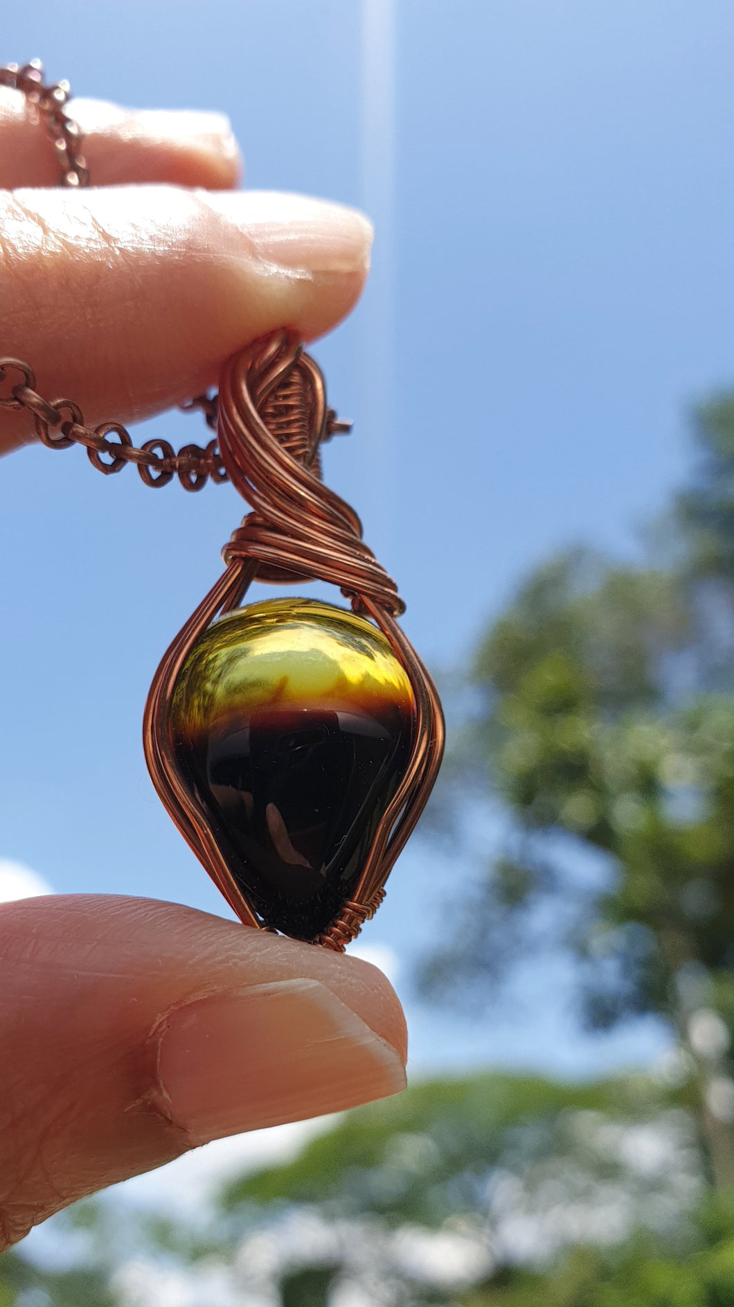 Natural Warm Yellow and Smoky Brown Coloured Baltic Amber Pear-shaped Cabochon Wire Wrapped Pendant