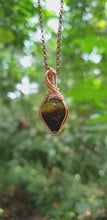 Load and play video in Gallery viewer, Natural Warm Yellow and Smoky Brown Coloured Baltic Amber Pear-shaped Cabochon Wire Wrapped Pendant
