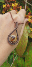 Load and play video in Gallery viewer, Ammonite Spiral Fossil Shell Pendant in Antiqued Copper Wire
